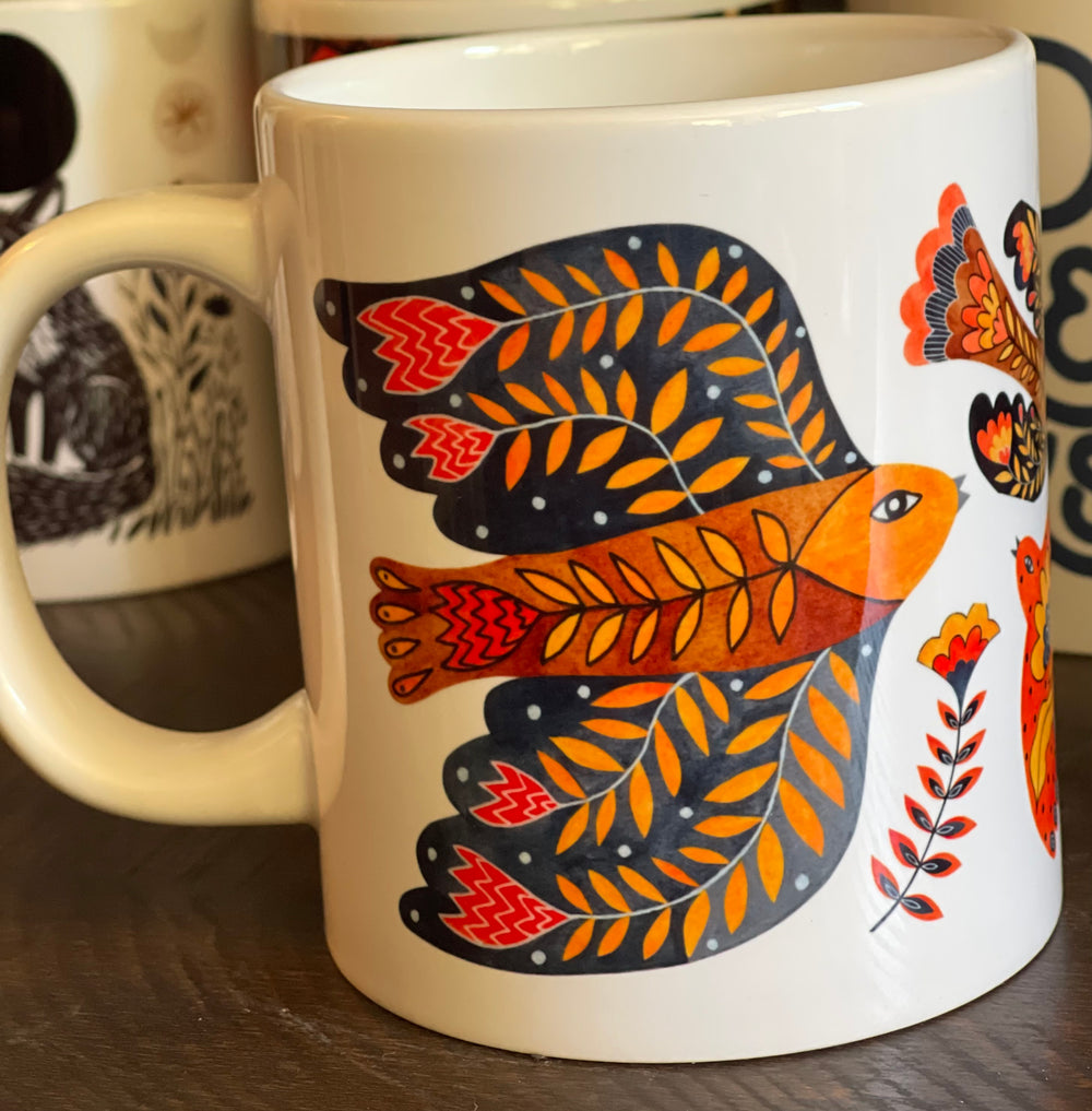 Large white mug with colorful water colored bird and flower elements.