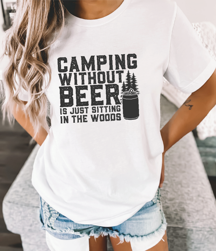 Woman wearing short sleeve tee with graphic: “Camping without beer is just sitting in the woods”.