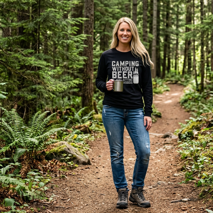 Woman in woods on hiking trail wearing black long sleeve shirt, with "Camping without beer is just sitting in the woods" graphic.