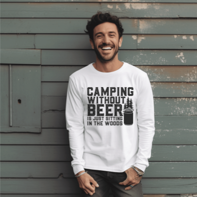 Smiling man in white long sleeve tee with black graphic: “Camping without beer is just sitting in the woods”.