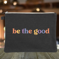 Black hemp zipper pouch with “Be The Good” graphic on it.