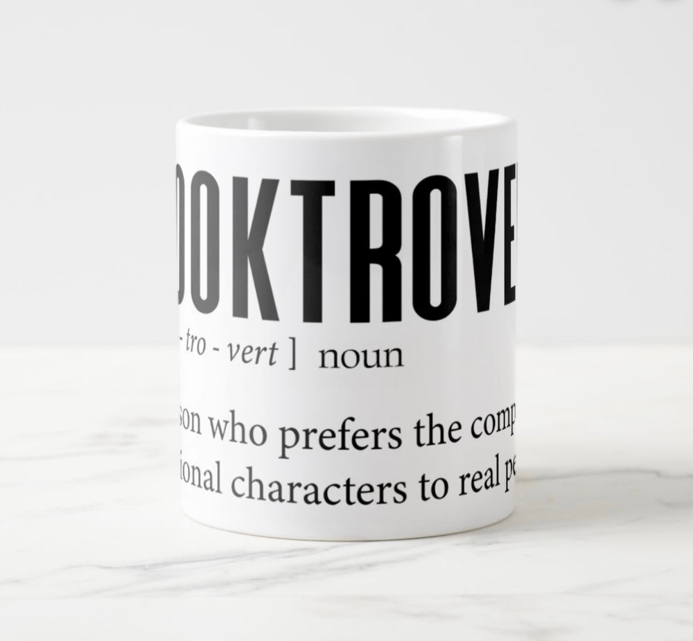 Large white mug with graphic: “Booktrovert: Book-tro-vert, noun. A person who prefers the company of fictional characters to real people.”