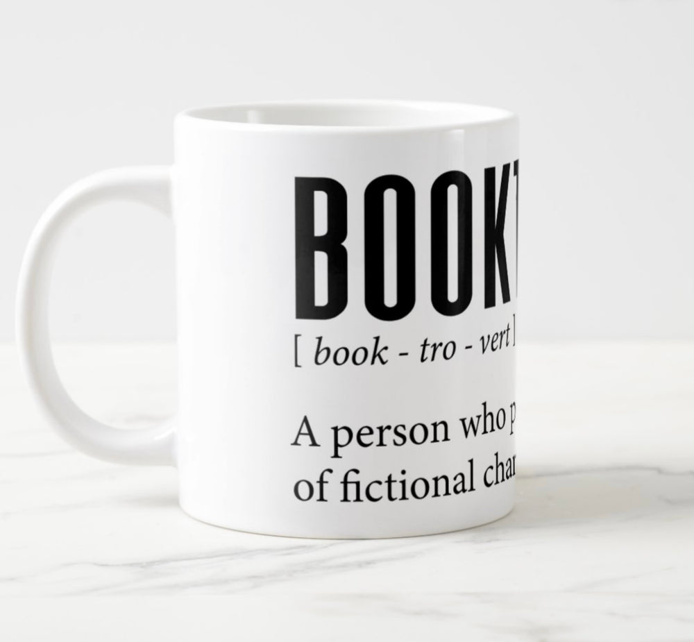 Large white mug with graphic: “Booktrovert: Book-tro-vert, noun. A person who prefers the company of fictional characters to real people.”