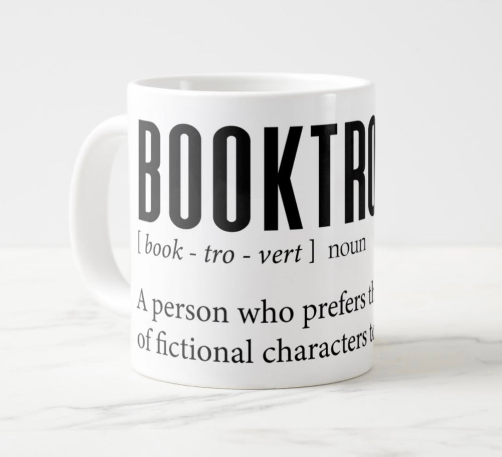 Large white mug with graphic: “Booktrovert: Book-tro-vert, noun. A person who prefers the company of fictional characters to real people.”