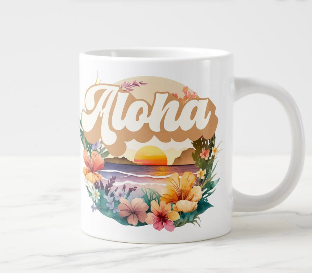 Large white mug with colorful sunset and flowers graphic with word “Aloha”.