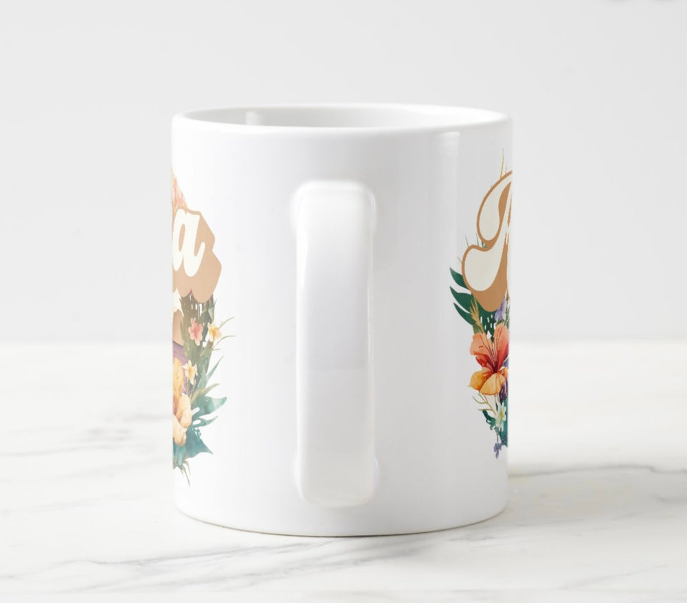 Large white mug with colorful sunset and flowers graphic with word “Aloha”.