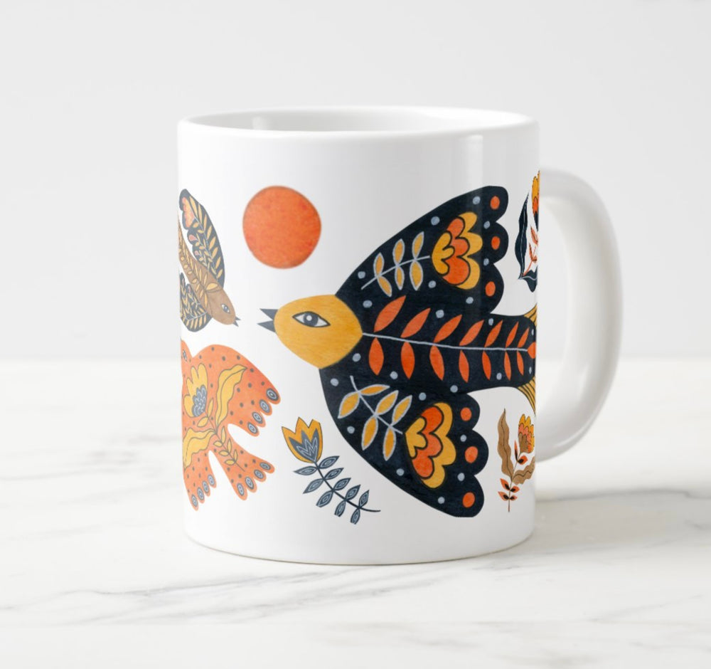 Large white mug with colorful water colored bird and flower elements.