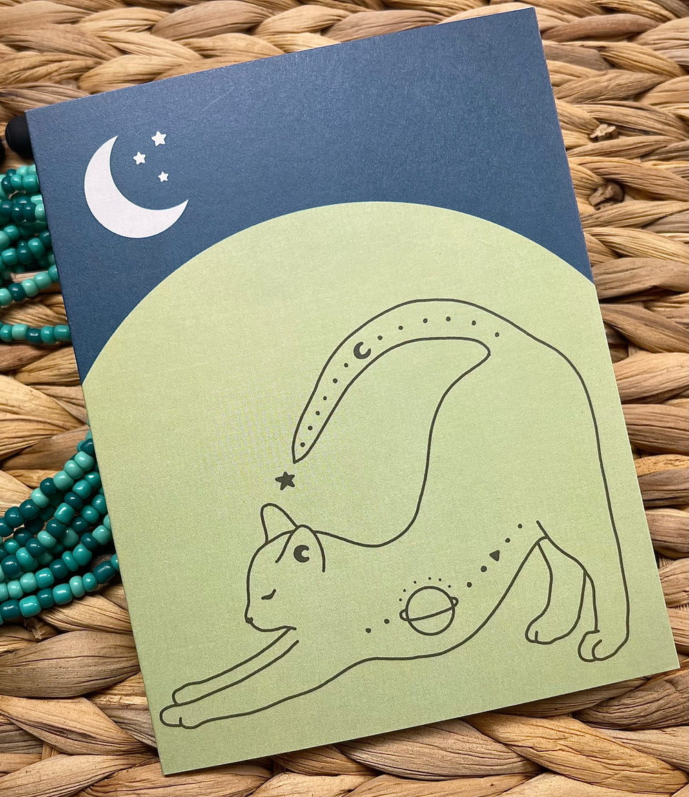 Greeting card with stretching cat and crescent moon graphic.