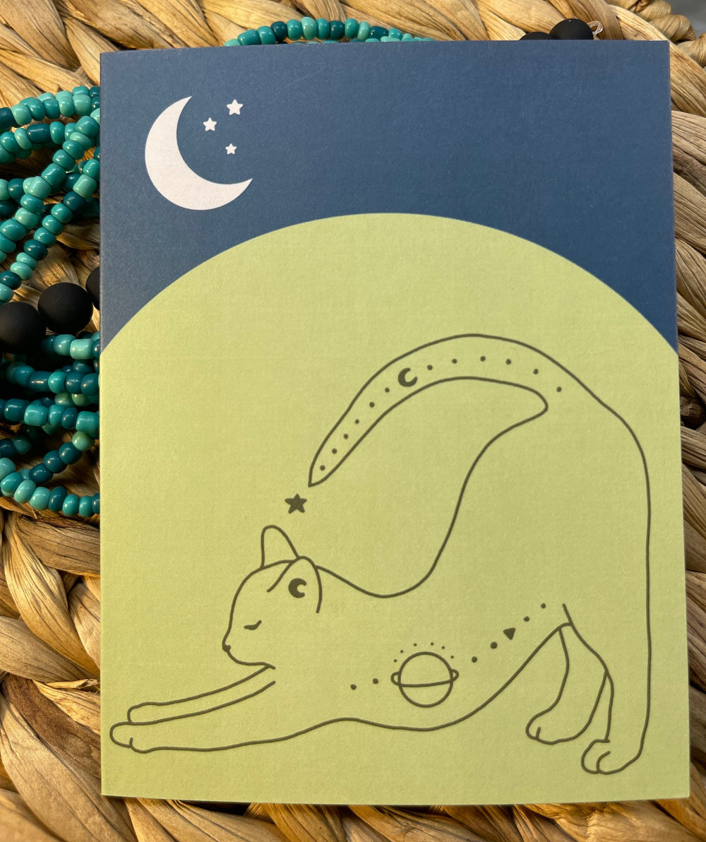 Greeting card with stretching cat and crescent moon graphic.