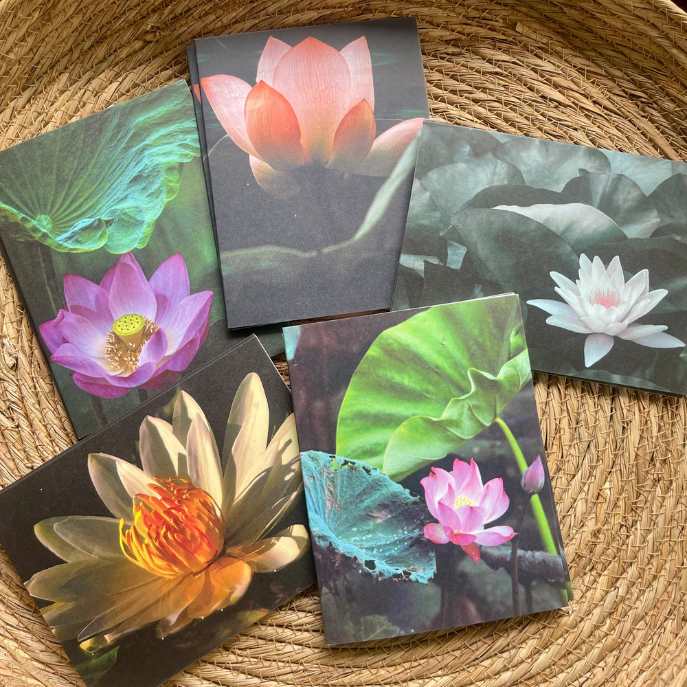 Set of six postcards with waterlily designs on a woven surface