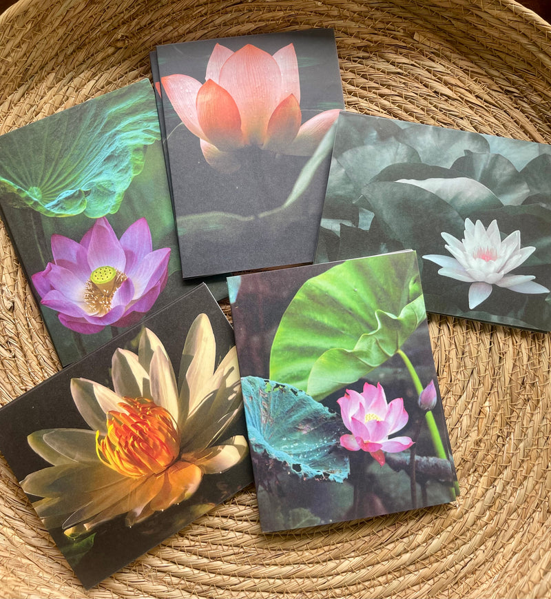 Set of six postcards with waterlily designs on a woven surface