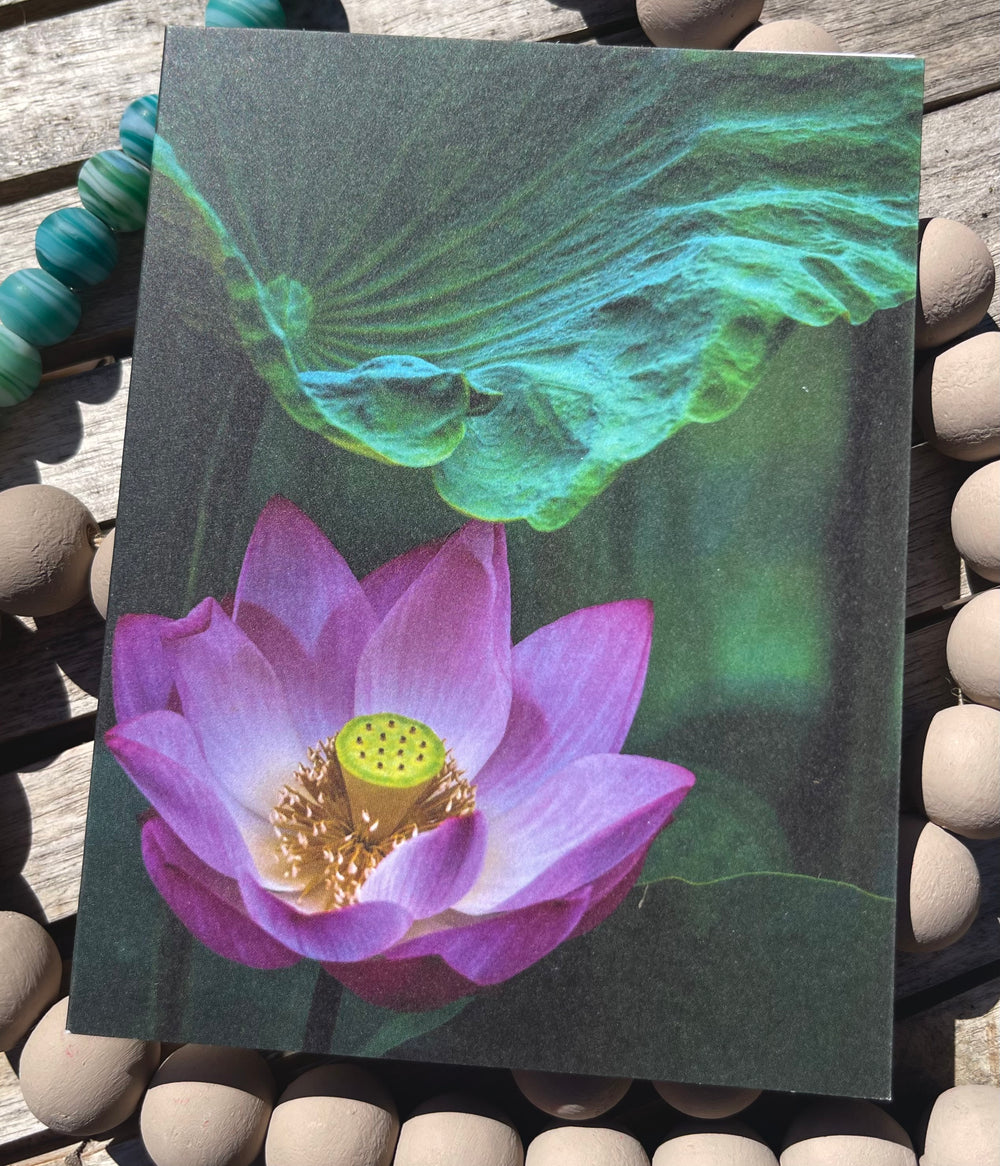Notebook with a pink lotus flower design on a textured surface