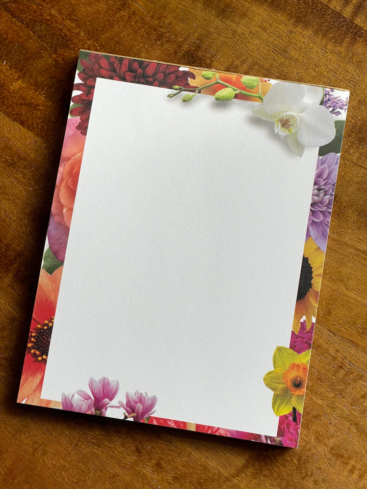 Floral notepad on a wooden surface