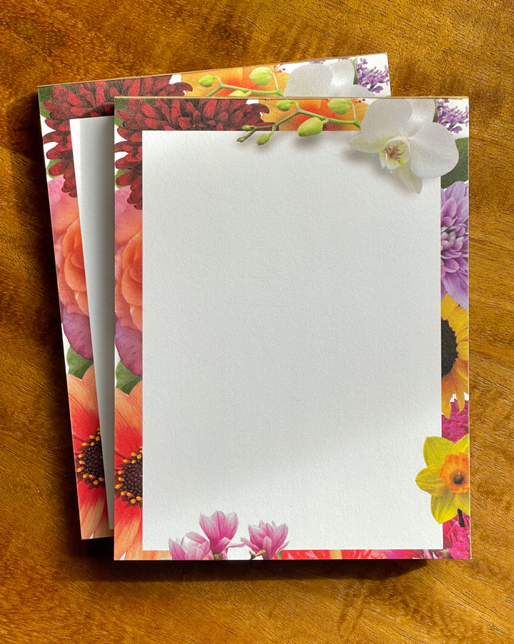 Floral design notepad on a wooden surface