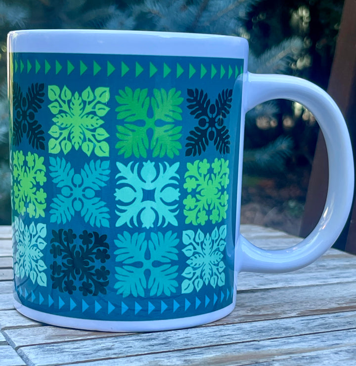 Mug with geometric Hawaiian quilt  pattern on a wooden surface