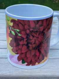 Mug with a red flower design on a wooden surface
