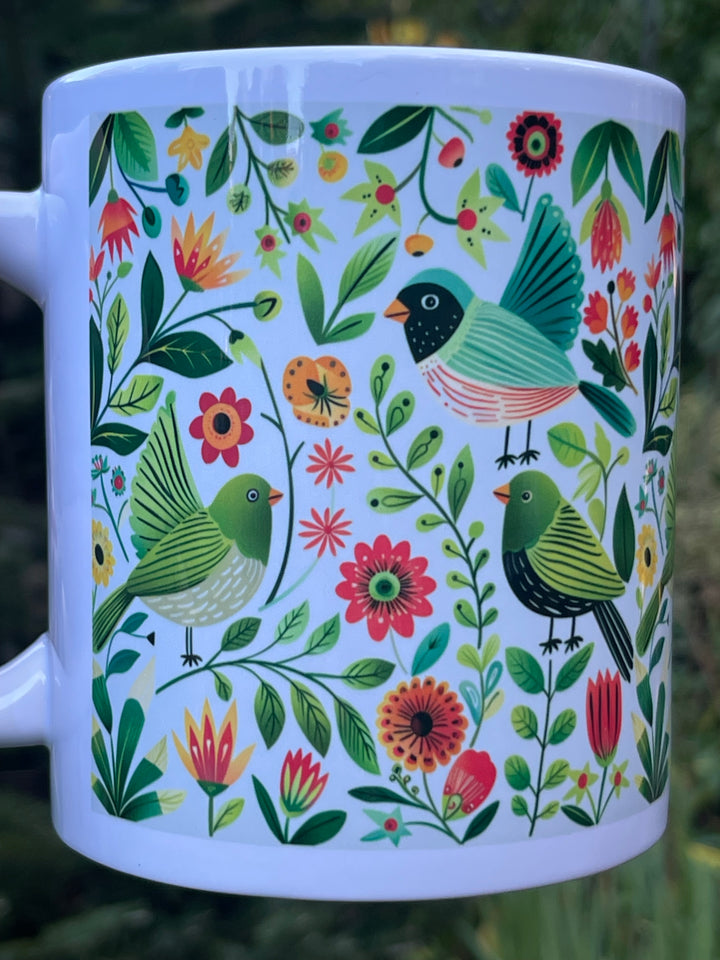 Mug with colorful bird and floral pattern on a white background