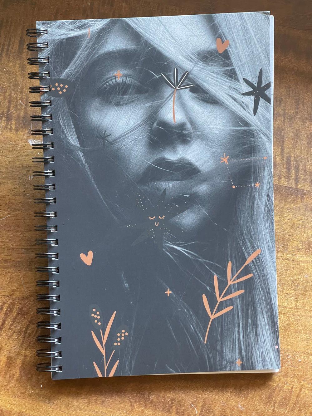 Spiral-bound notebook, featuring black and white image of young bohemian woman.