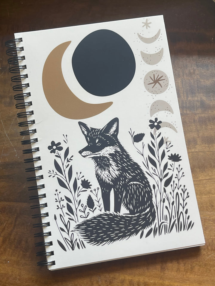 Spiral-bound notebook featuring a fox and crescent moon graphic.