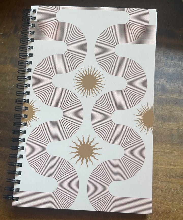 Front of spiral-bound notebook, featuring linear abstract design.
