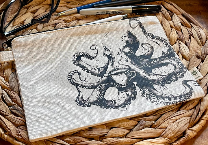 Beige pouch with black octopus design on a woven surface