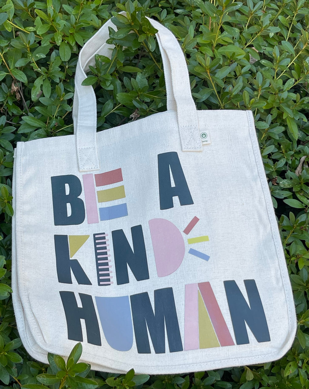 Tote bag with “Be A Kind Human” in playful graphic text.