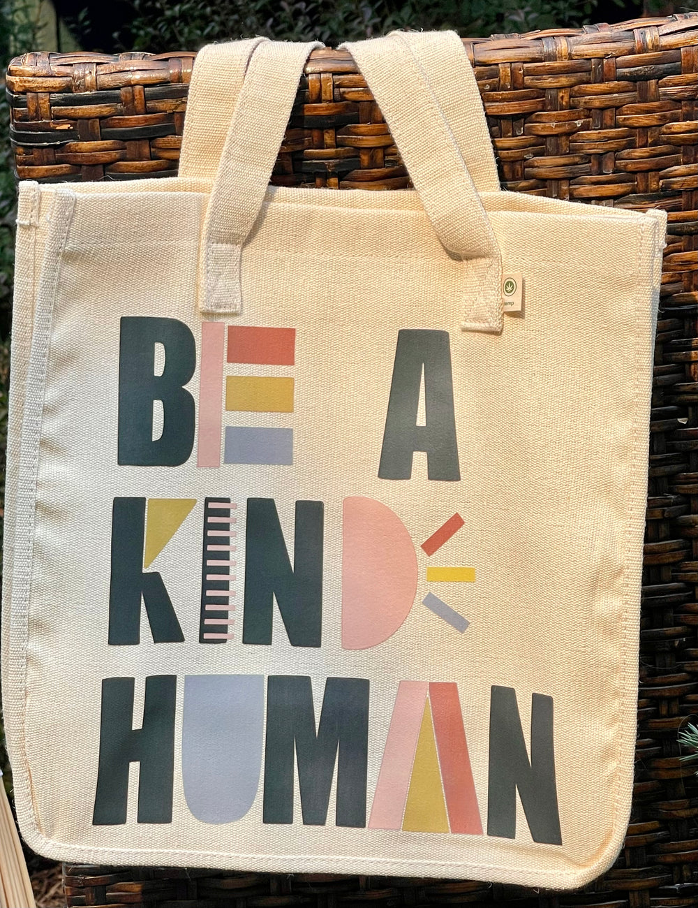 Tote bag with “Be A Kind Human” in playful graphic text.