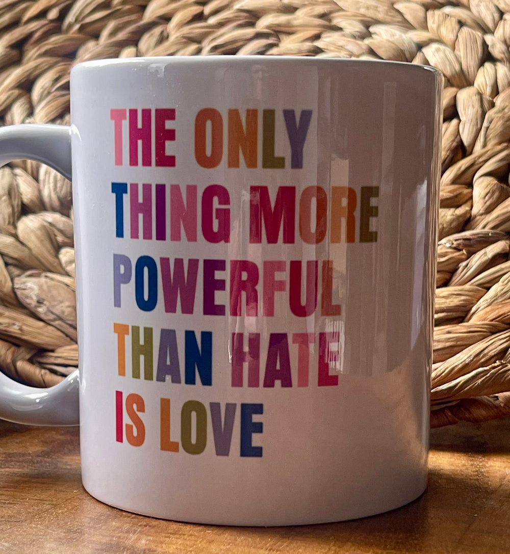 White mug with colorful text on a woven mat background