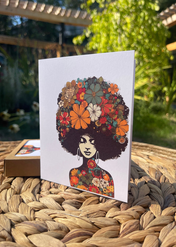 Greeting card featuring illustration of bohemian woman with lots of flowers in her natural hair.