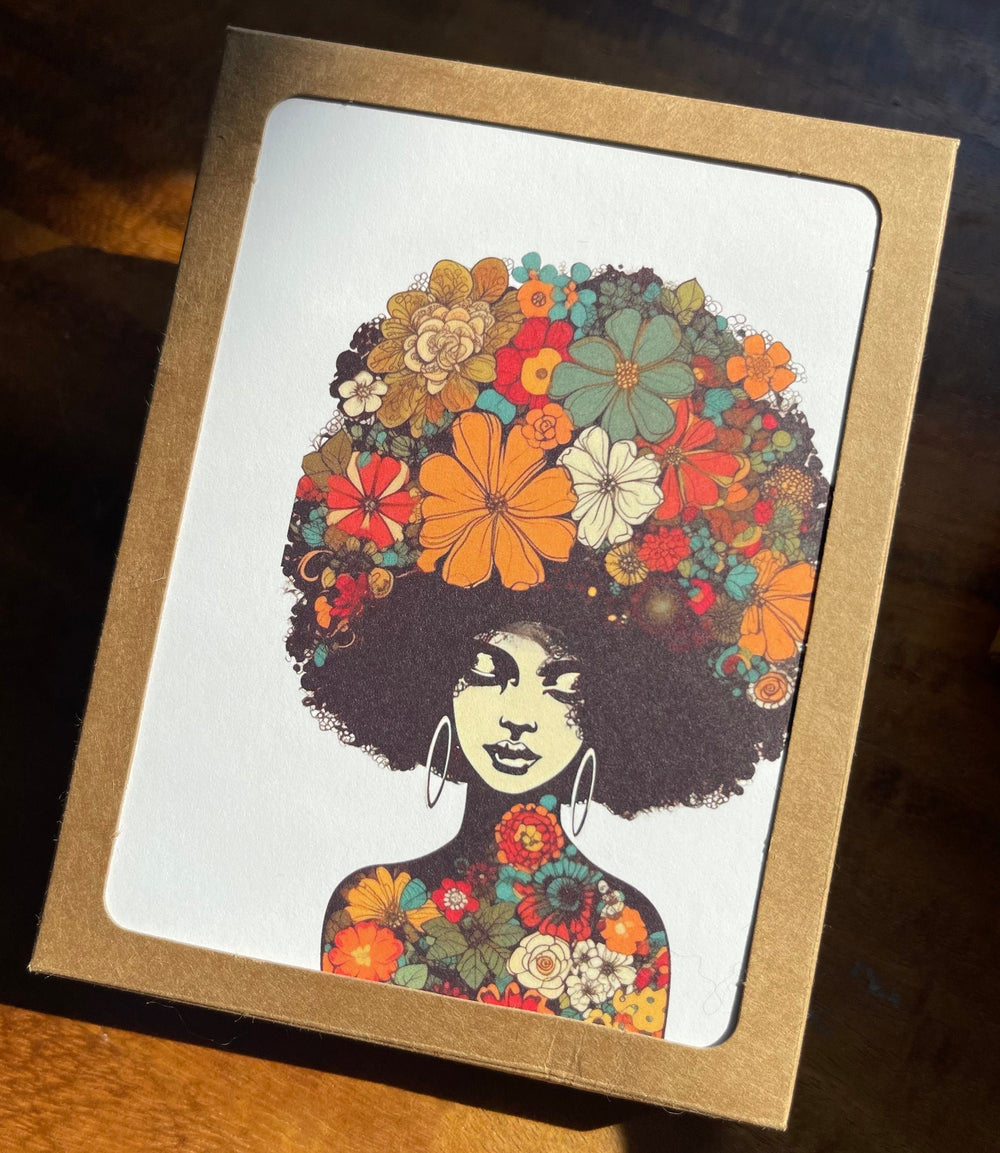 Box of greeting cards featuring illustration of bohemian woman with lots of flowers in her natural hair.