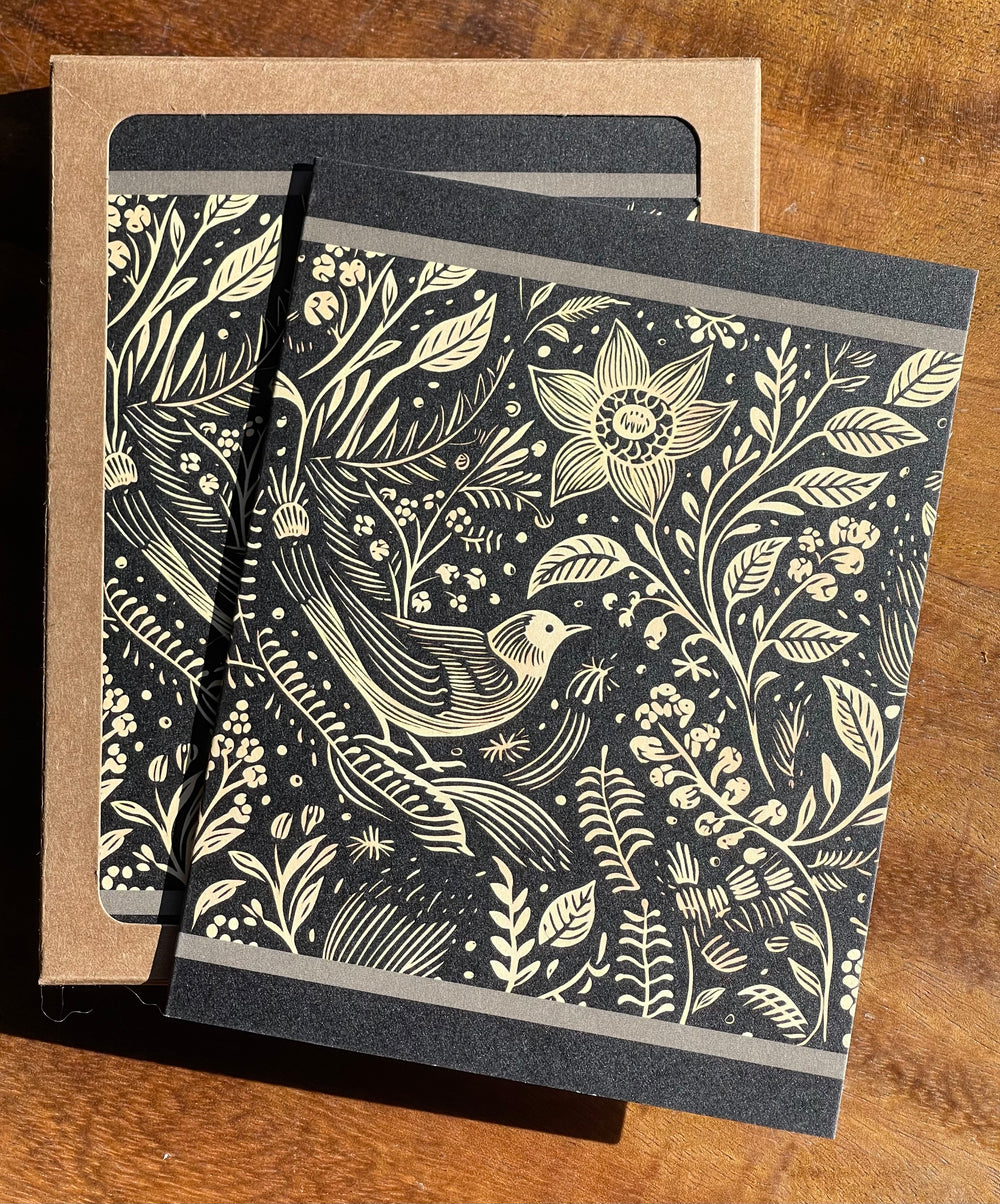 Greeting card with black and beige illustration of a bird and flowers.