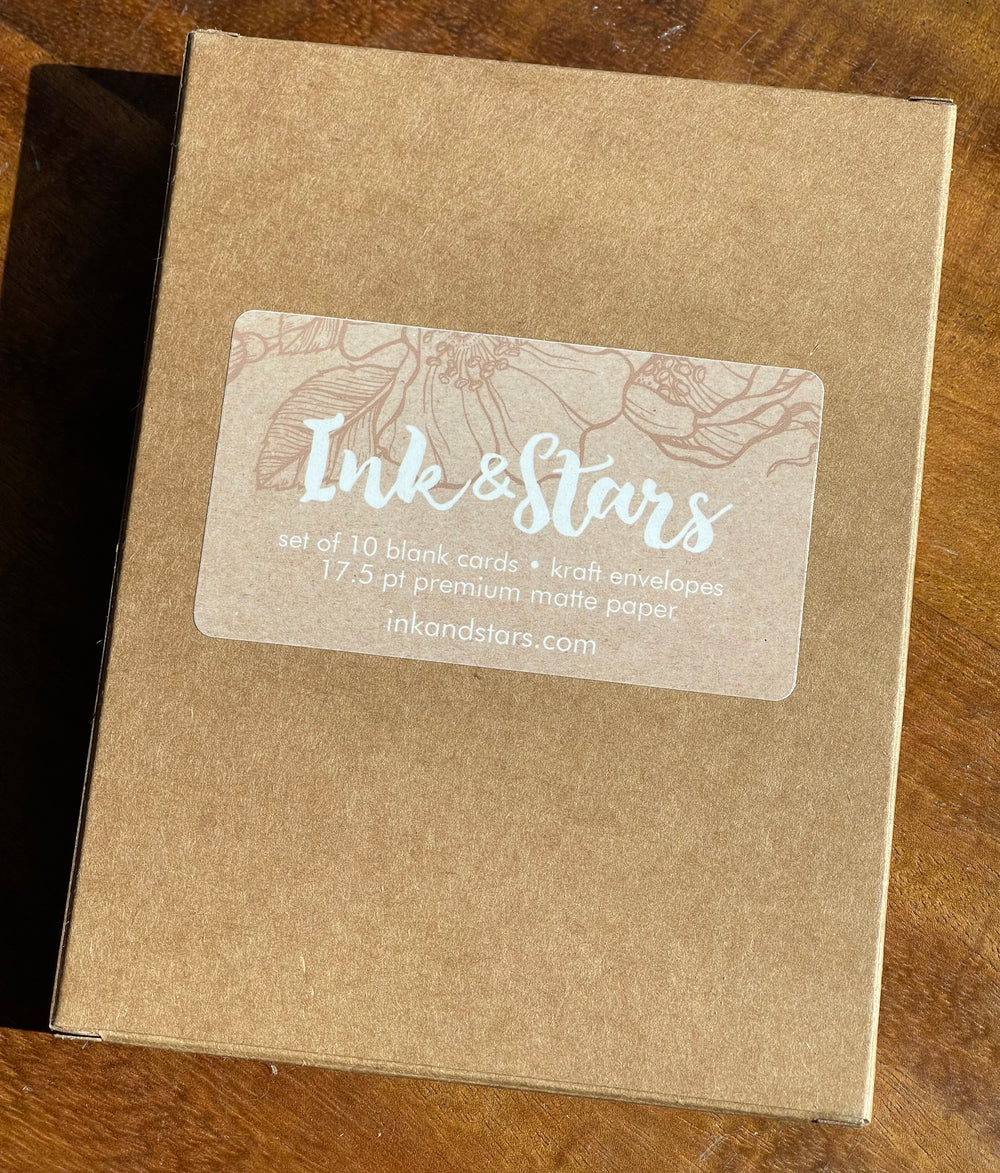 Back of greeting card box showing Ink & Stars logo, URL, and product specs.