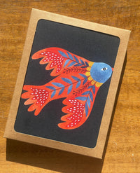 card with red folklore bird on dark background