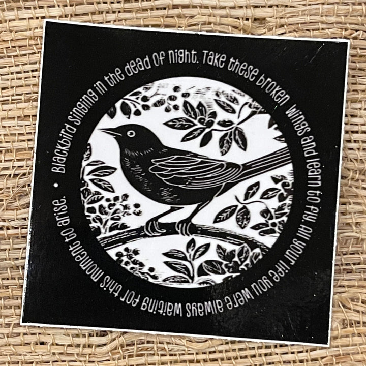 Black and white square sticker, with black bird illustration, and lyrics from the Beatle’s “Blackbird” song circling the image.