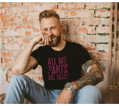 Man wearing a short sleeve black tee with “All My Pants Are Sassy” graphic.