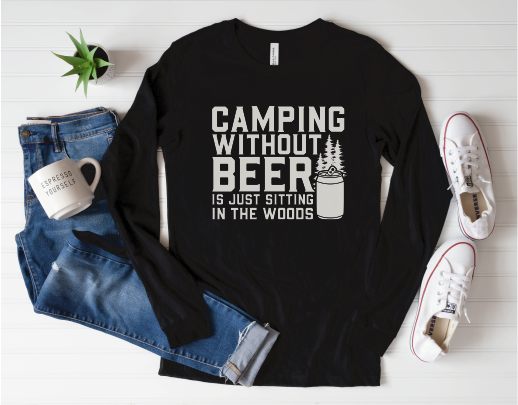 Flay lay with casual life props, showcasing black long sleeve tee with white graphic: “Camping without beer is just sitting in the woods”.