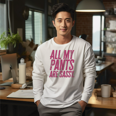 Young man wearing a long sleeve white tee with “All My Pants Are Sassy” graphic.