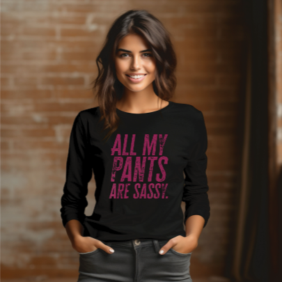Young woman wearing a long sleeve black tee with “All My Pants Are Sassy” graphic.