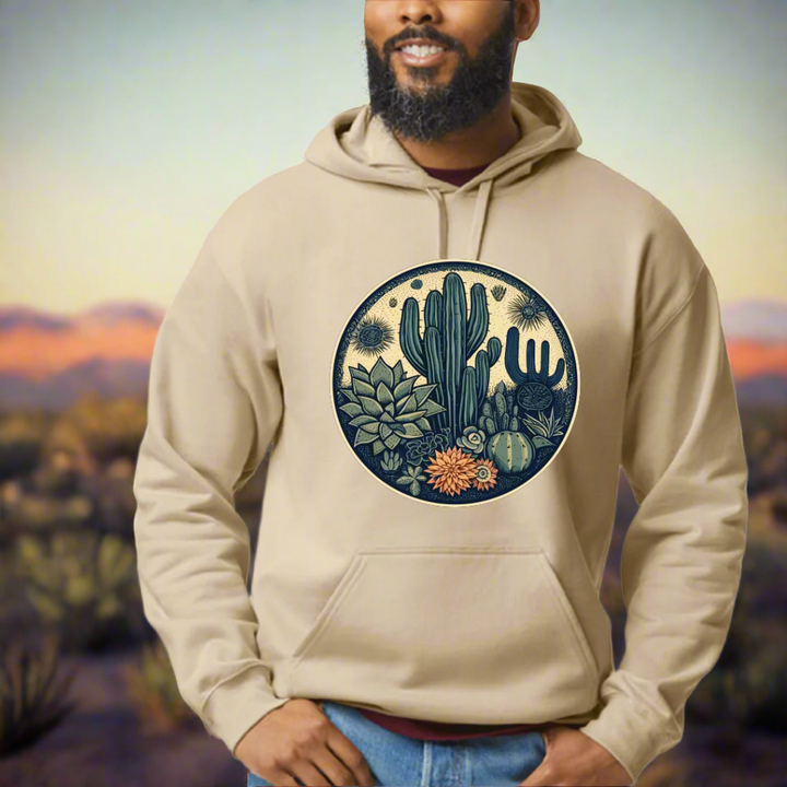 Man wearing beige sweatshirt with desert plants graphic.