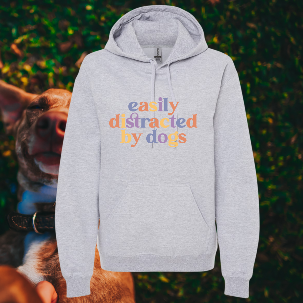 “Easily Distracted By Dogs” graphic on light grey hooded sweatshirt.