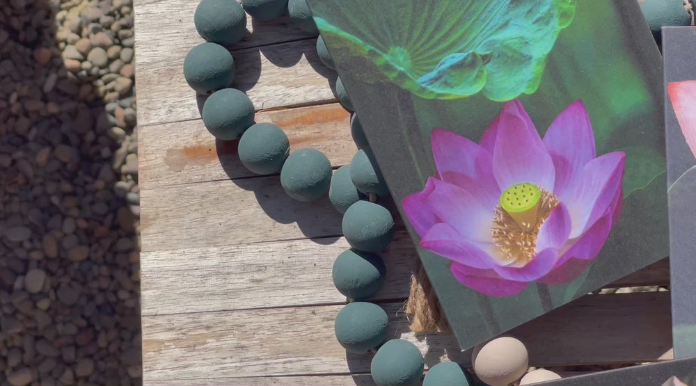 Video of tabletop with lotus blossom cards, colored beads in background.